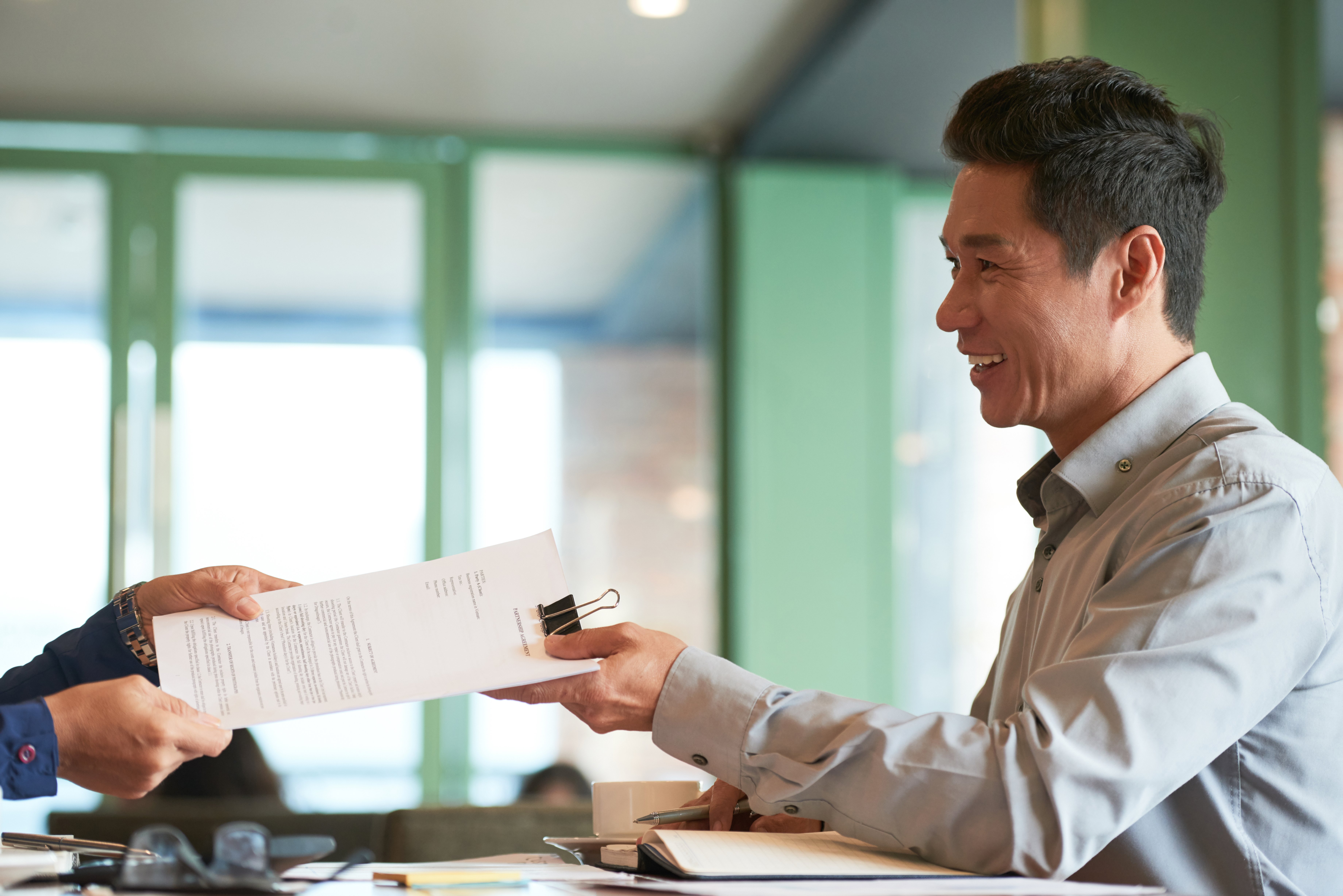 Happy Hong Kong residents holding tax clearance documents